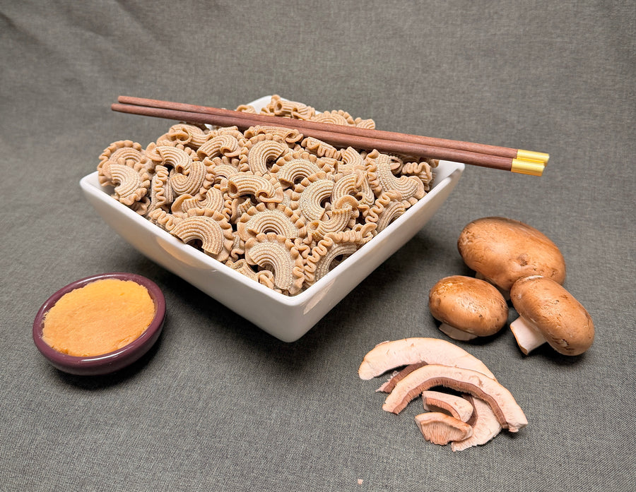 Dried rooster comb mushroom slices in a white bowl with tan curled pieces